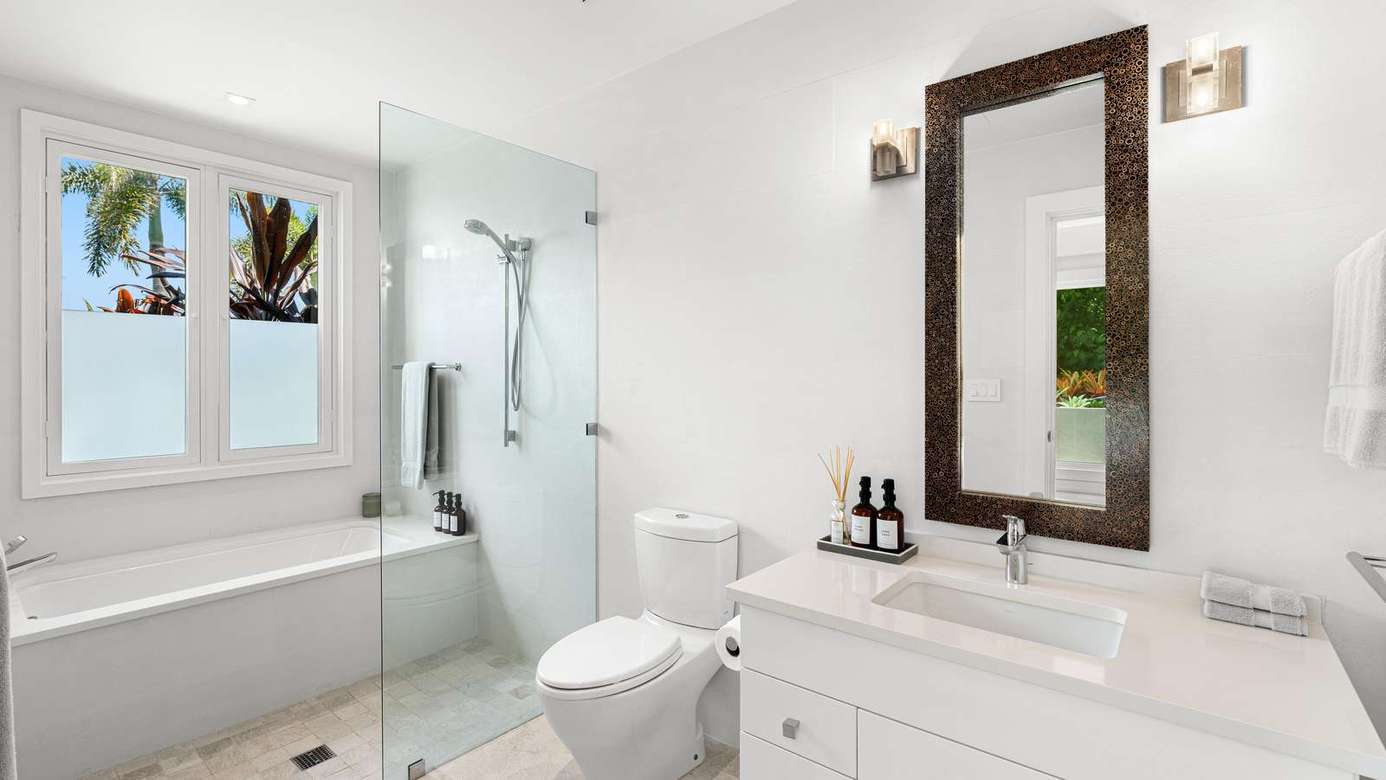Bright, modern bathroom with spacious walk-in shower and natural light