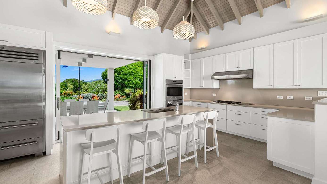 Spacious kitchen with sleek appliances and garden views