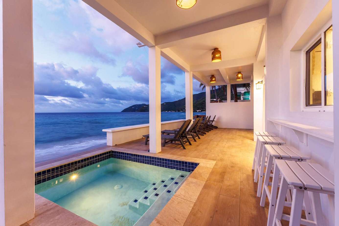 Oceanfront patio with private hot tub and sunset views