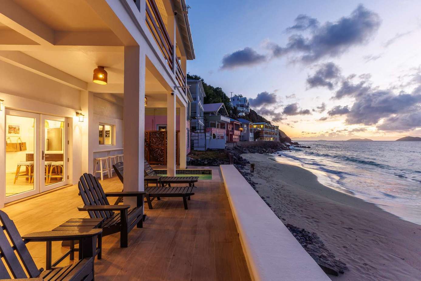 Oceanfront patio with stunning sunset and beach views