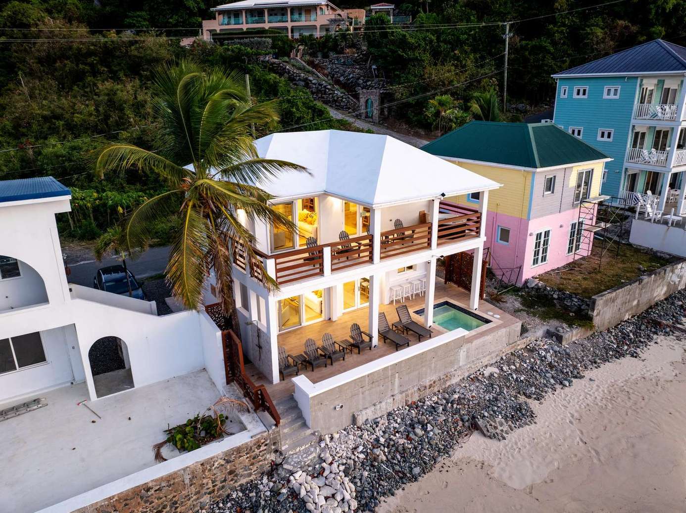 Oceanfront patio with stunning sunset views and cozy seating