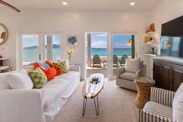 Sunlit living room with panoramic ocean views and cozy seating