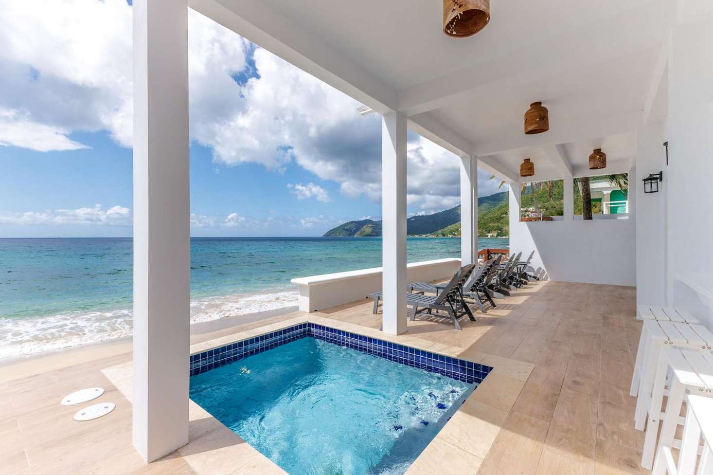 Oceanfront patio with private plunge pool and lounge chairs
