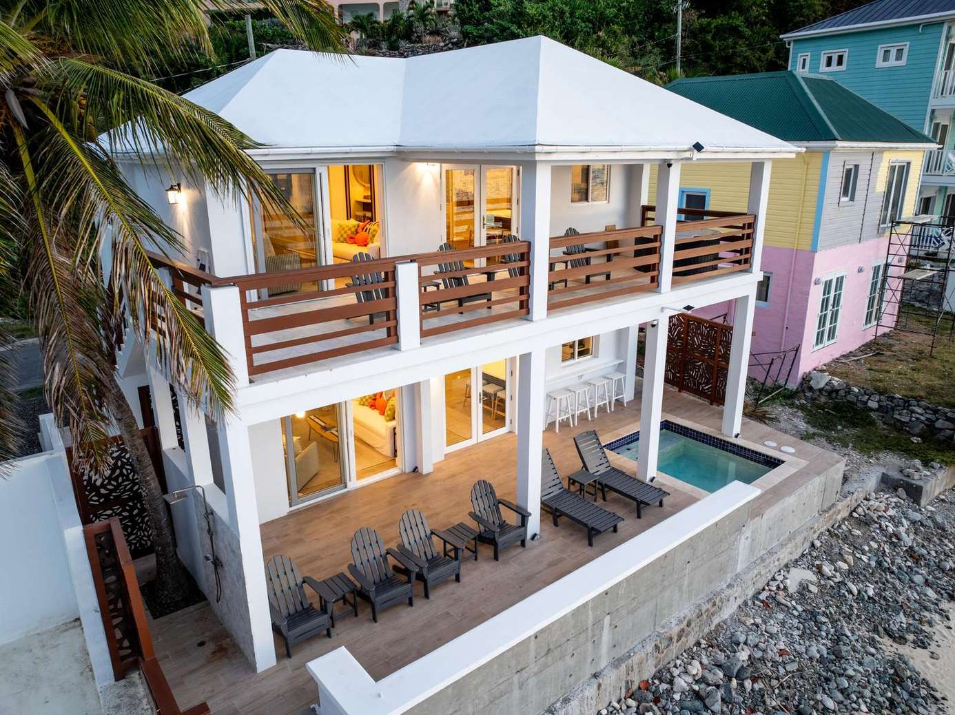 Oceanfront patio with stunning sunset views and cozy seating