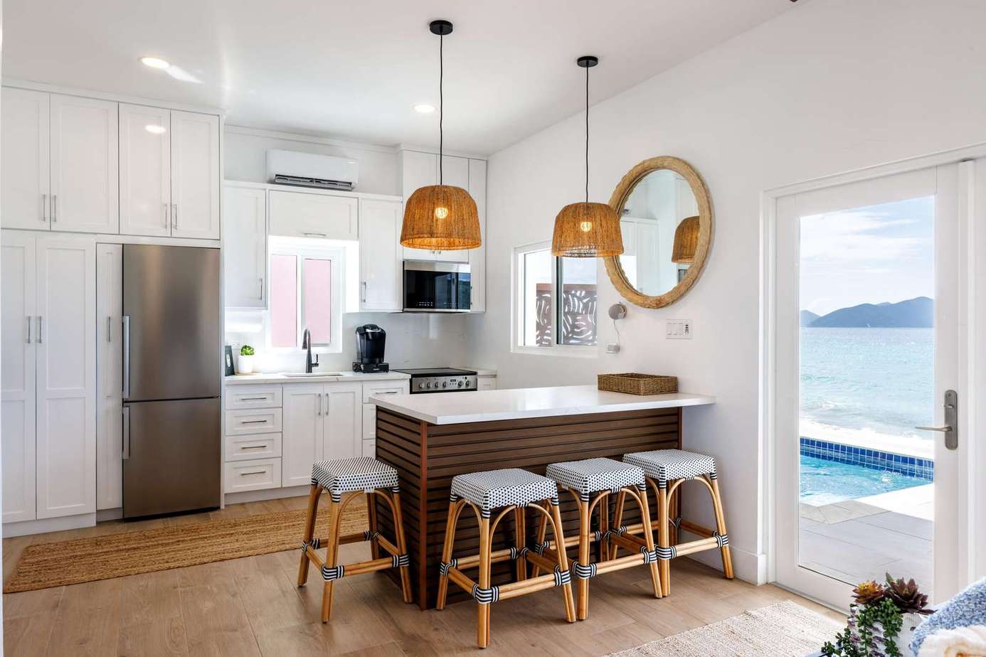 Bright, modern kitchen with ocean views and cozy breakfast bar