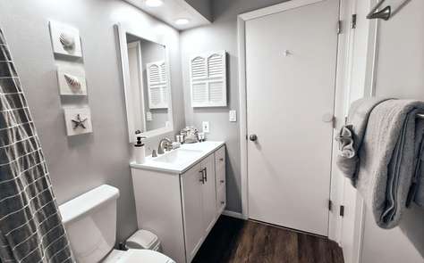 Bright, modern bathroom with coastal-inspired decor and ample storage