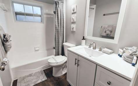 Bright, modern bathroom with full tub and fresh accents