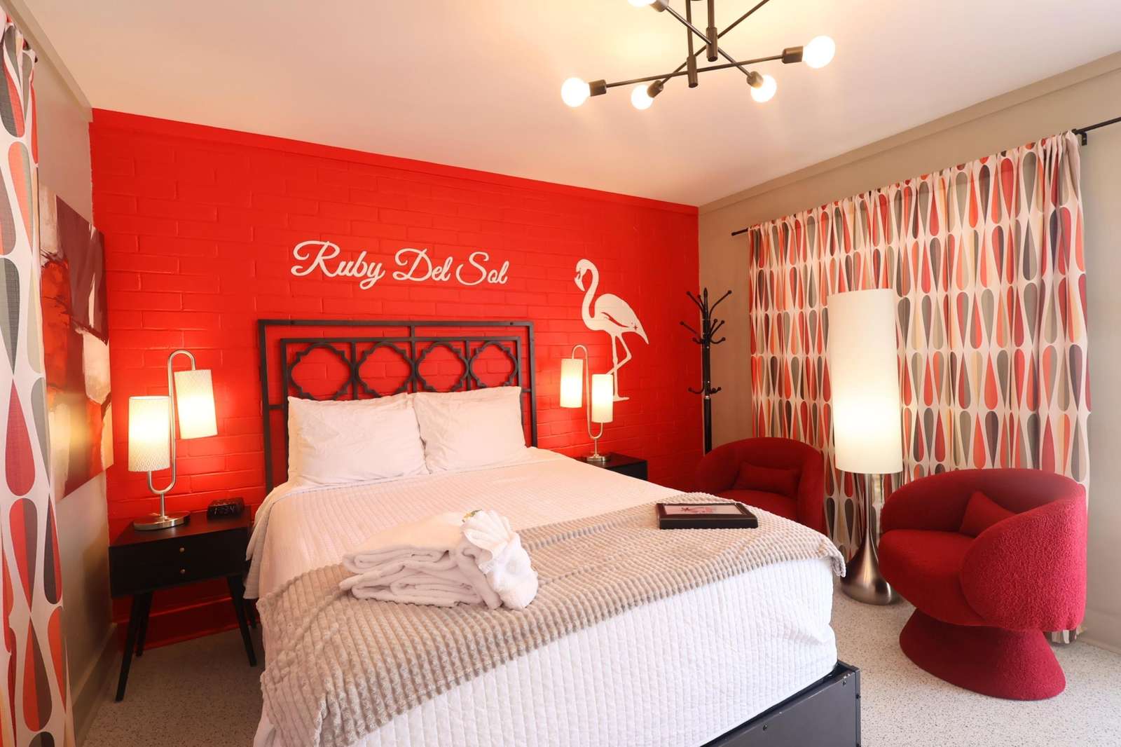 Cozy bedroom retreat with vibrant red accents and modern lighting - property