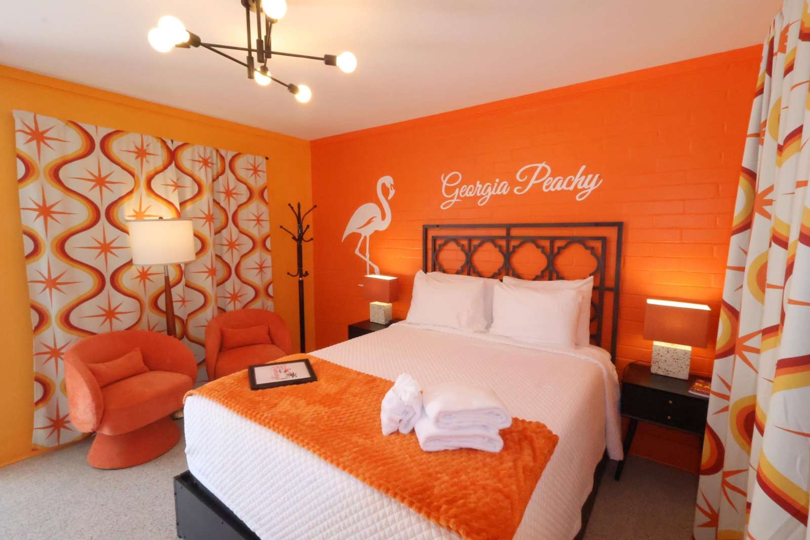 Vibrant bedroom retreat with cozy seating and bold decor - property