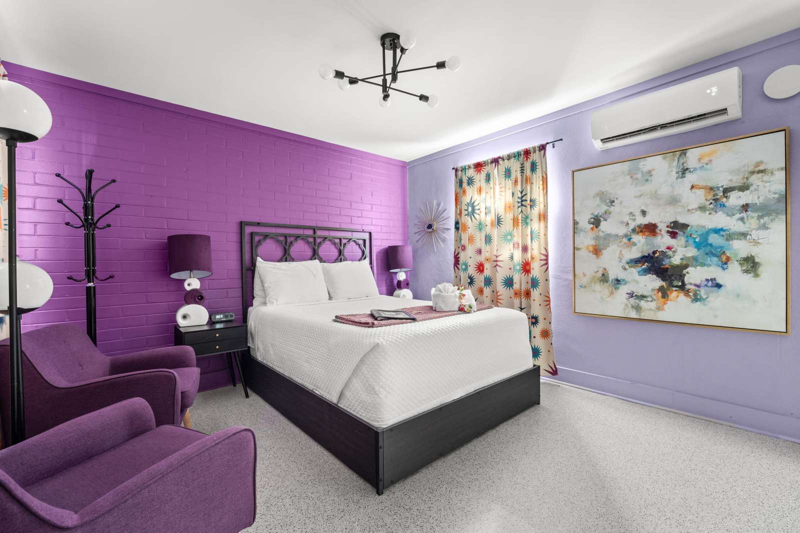 Vibrant bedroom retreat with cozy seating and modern art - property