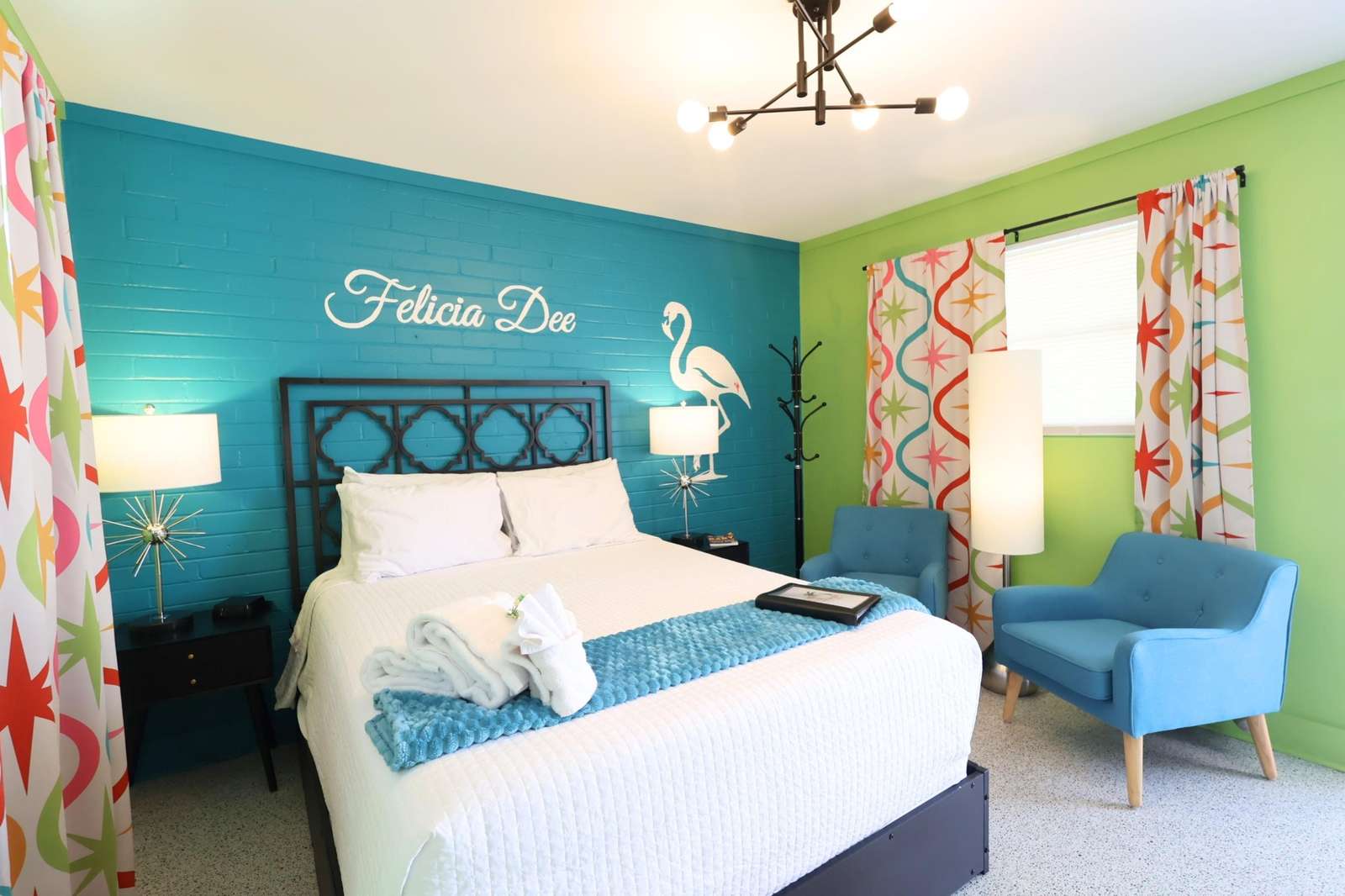 Bright, cheerful bedroom with vibrant colors and cozy seating - property