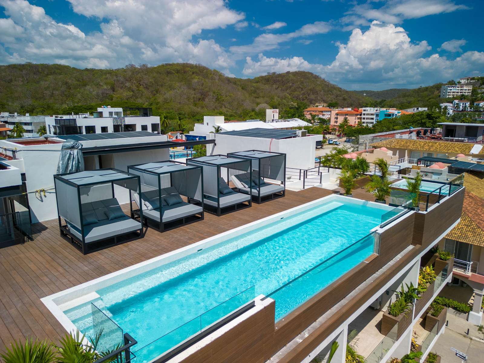 Rooftop pool and lounge with stunning mountain views - property