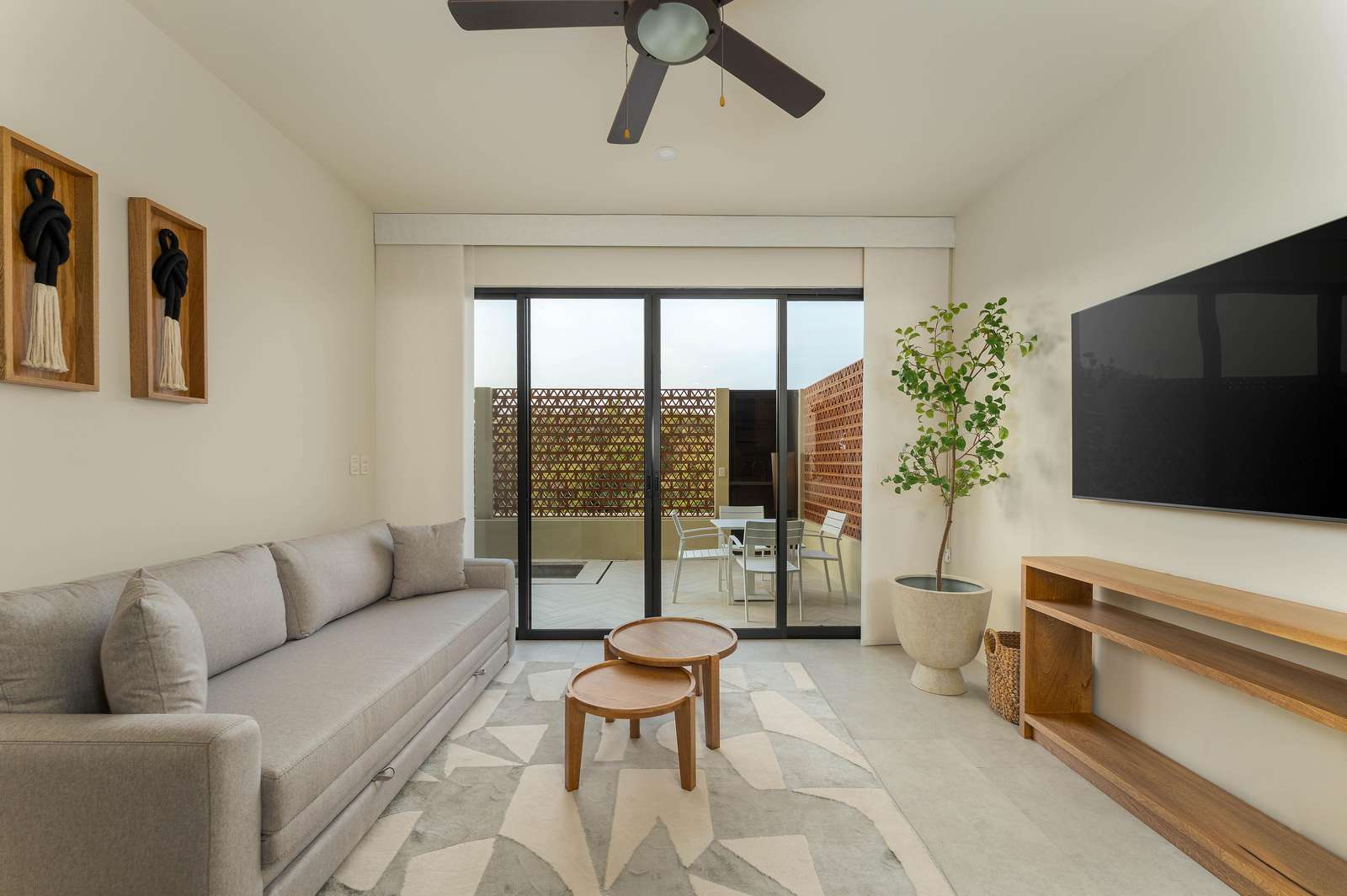 Bright living room with cozy seating and private patio access - property