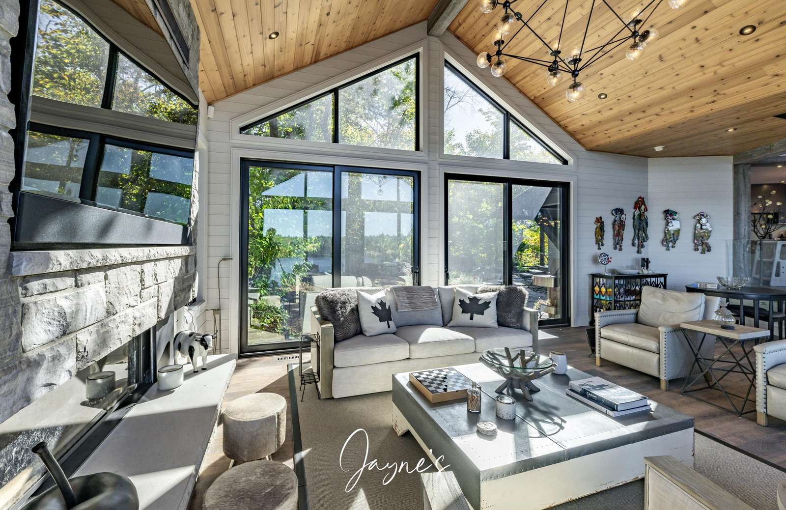 Sunlit living room with vaulted ceilings and lake views