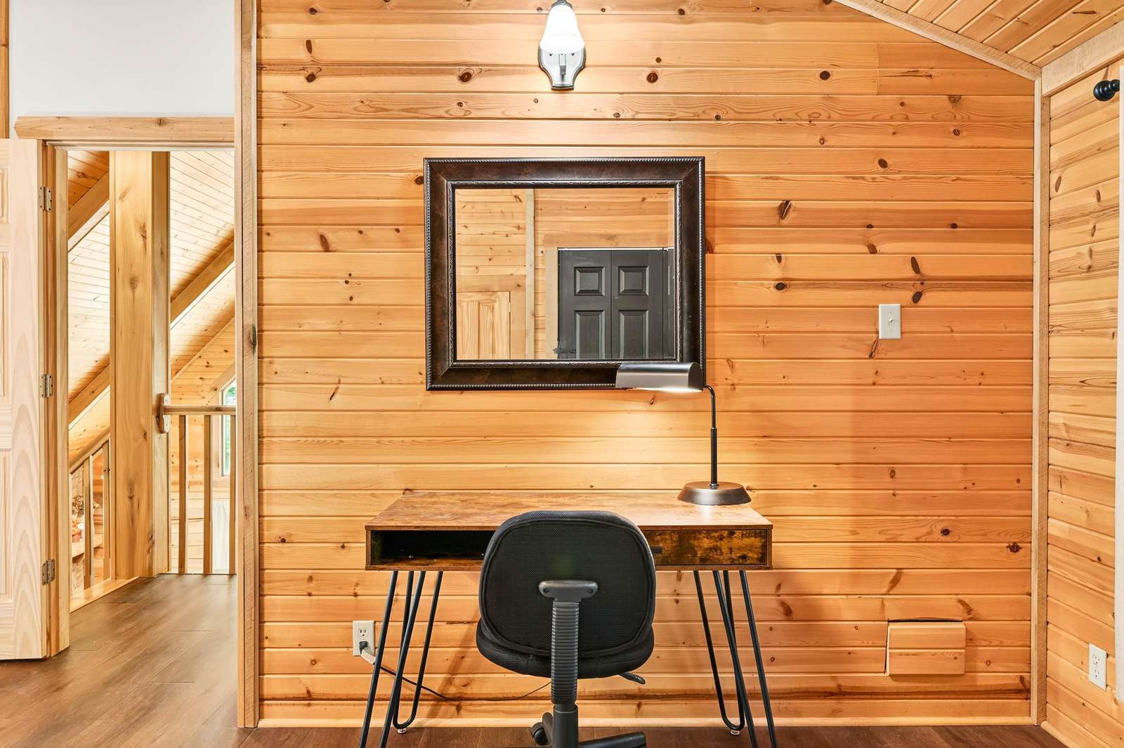 Cozy wooden nook with a stylish workspace and natural light