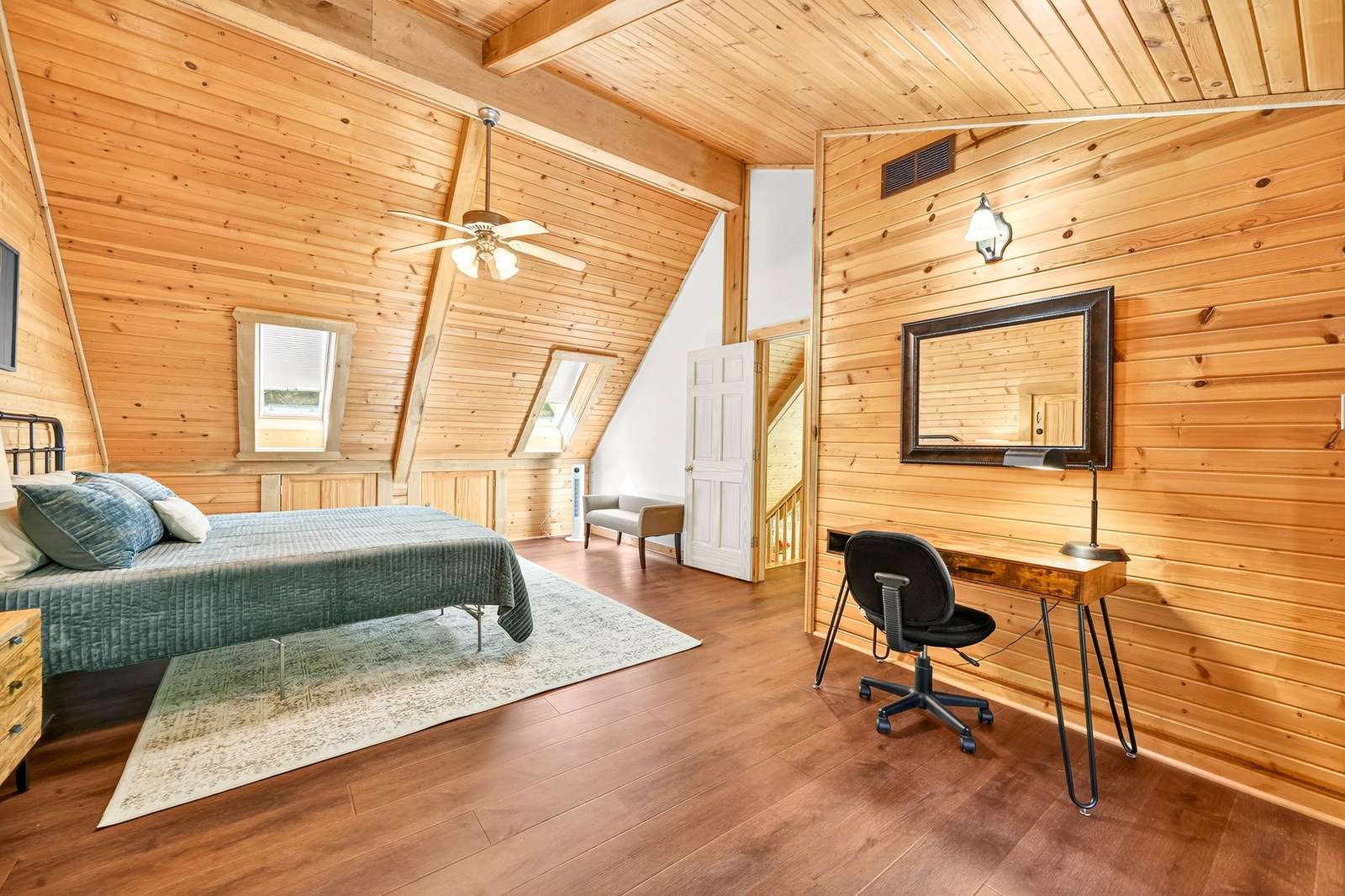 Cozy loft bedroom with vaulted ceilings and warm wood accents