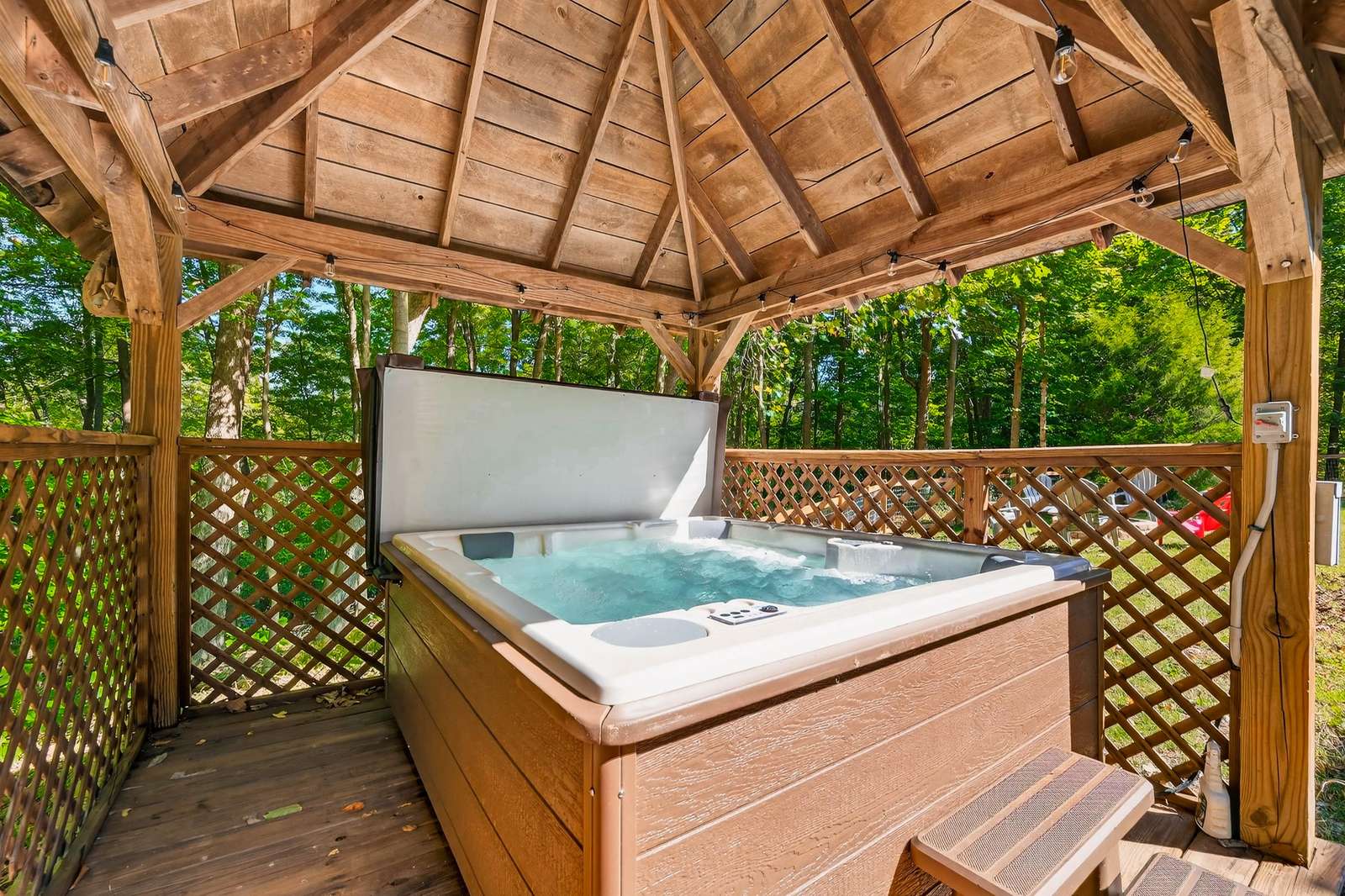 Secluded hot tub retreat under a charming wooden gazebo