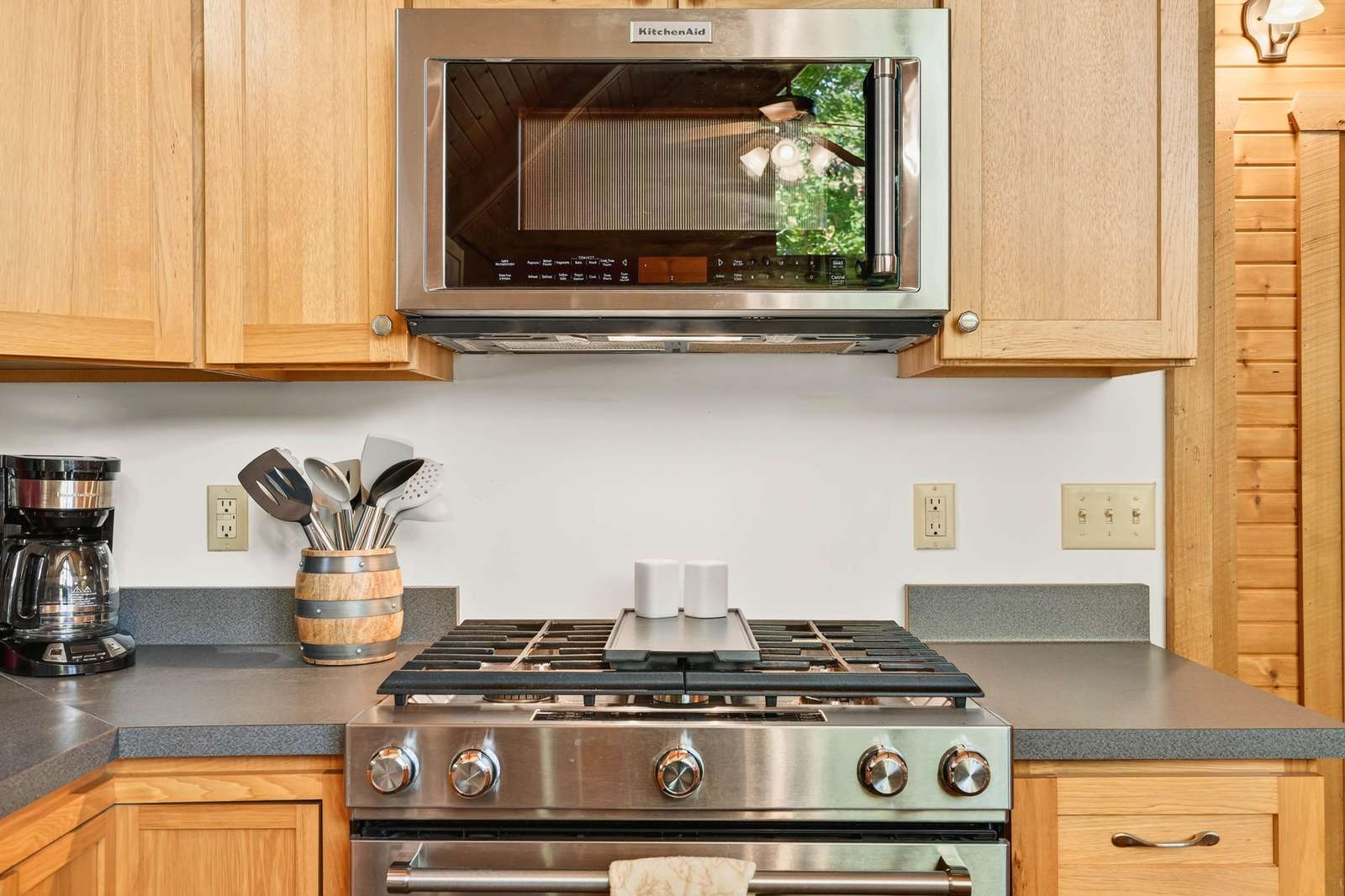 Modern kitchen with stainless steel appliances and warm wood cabinetry