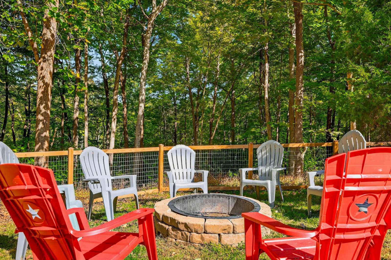 Cozy outdoor fire pit surrounded by vibrant Adirondack chairs