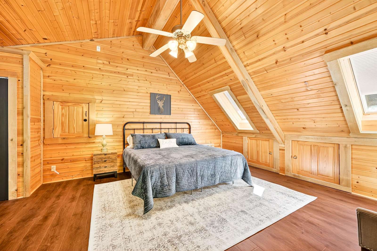Cozy attic bedroom with warm wood accents and natural light