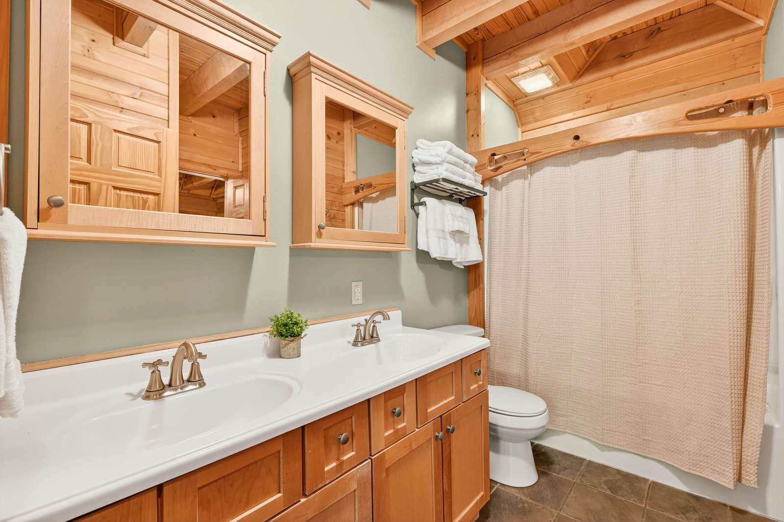 Cozy rustic bathroom with warm wood accents and bright lighting