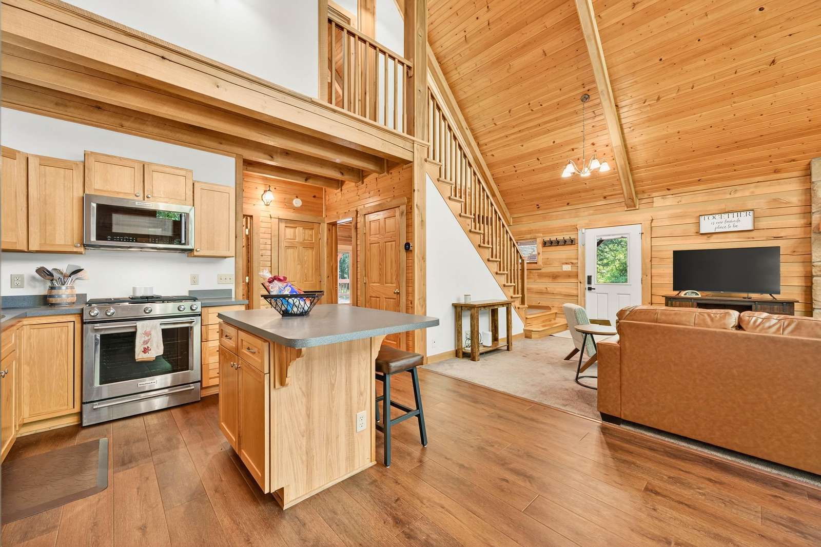Spacious open kitchen and living area with vaulted ceilings