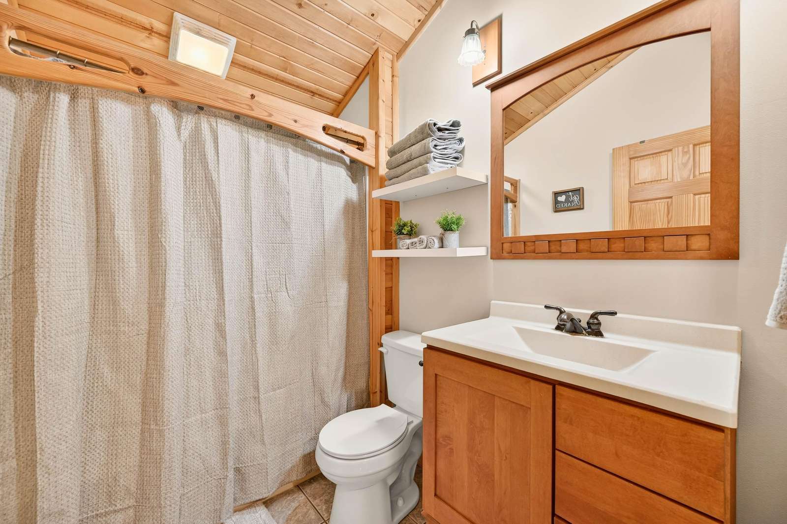 Cozy bathroom with warm wood accents and bright lighting