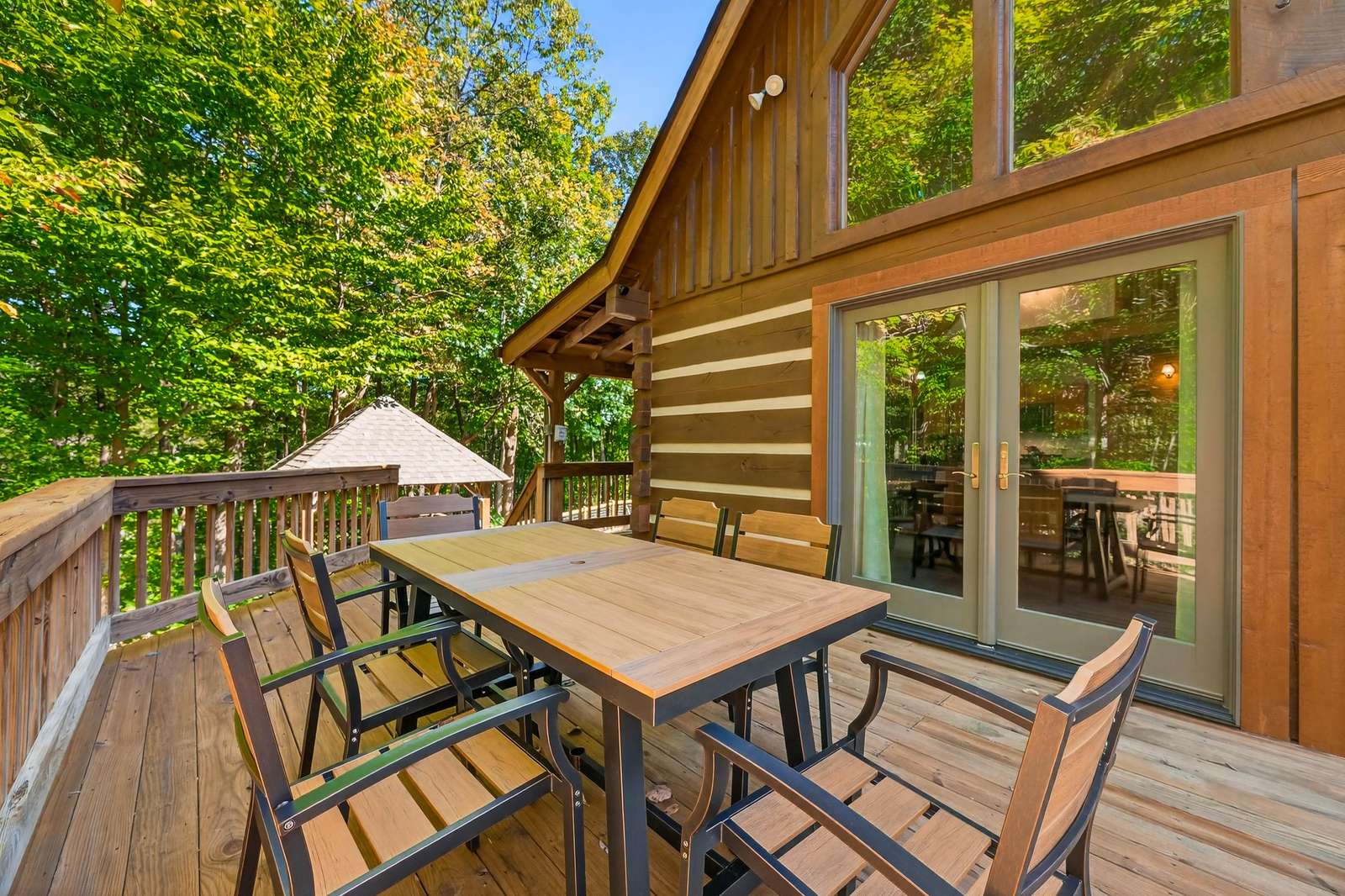 Spacious outdoor deck with forest views for relaxing meals