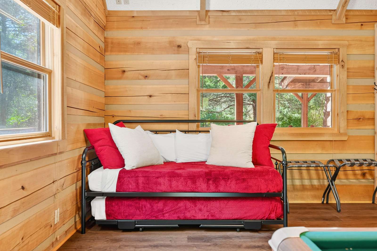 Cozy cabin living room with vibrant red sofa and natural light