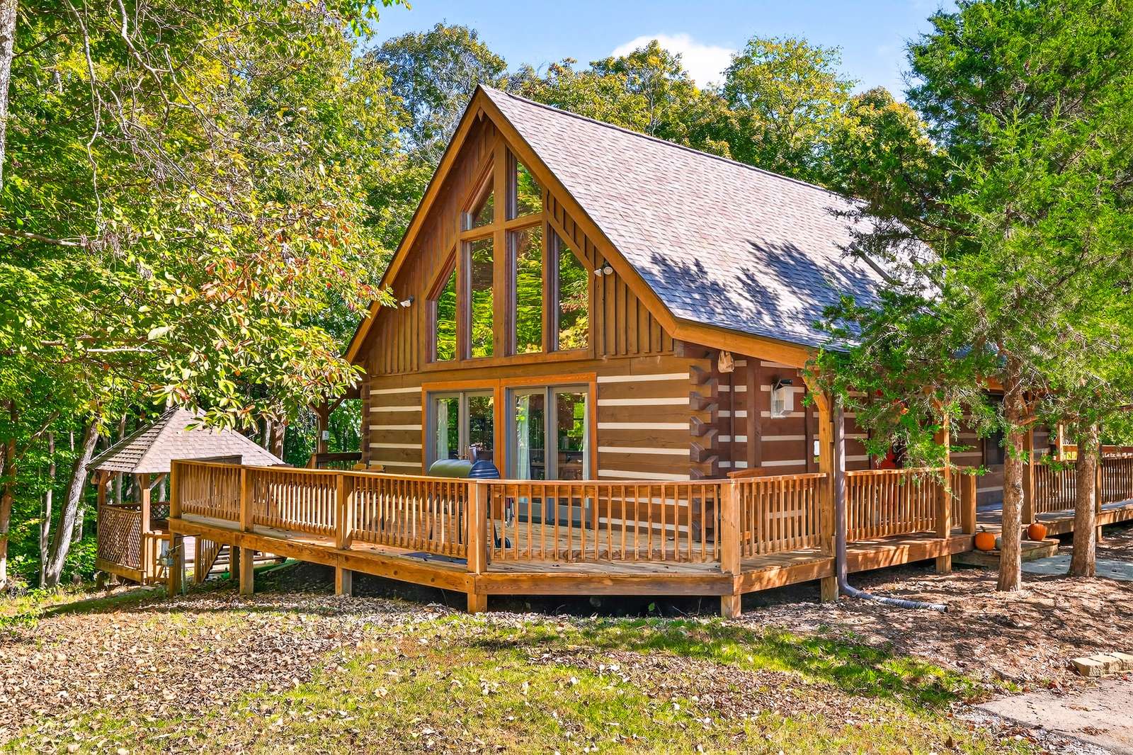 Spacious log cabin with expansive wraparound deck and forest views