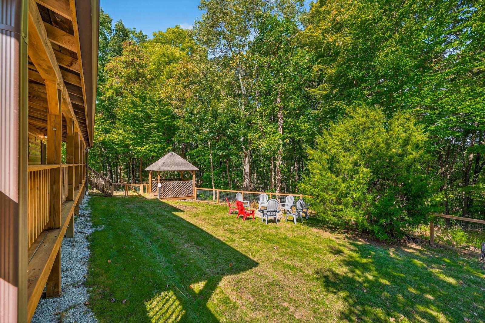Spacious backyard retreat with cozy gazebo and fire pit area