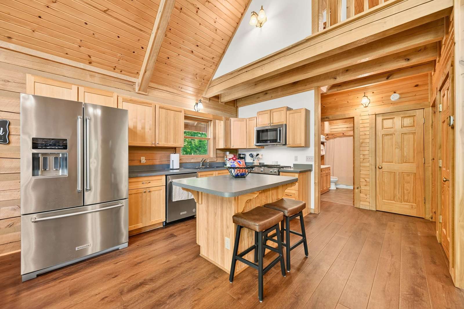 Spacious kitchen with modern appliances and cozy wood accents