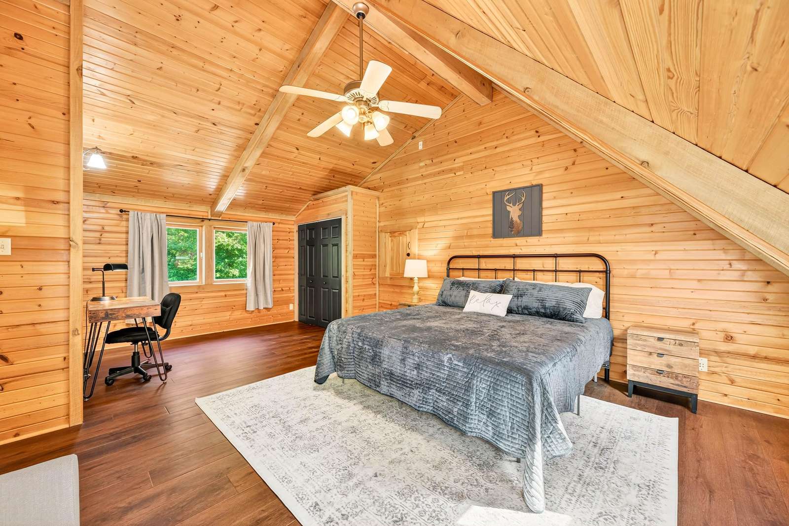 Cozy loft bedroom with vaulted ceilings and warm wood accents