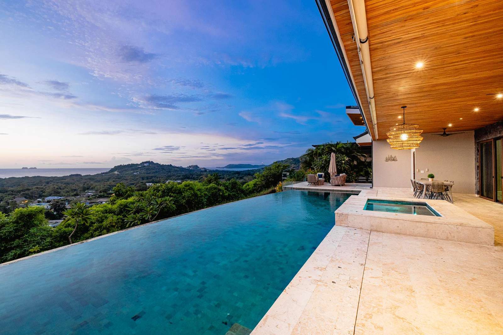 Infinity pool patio with breathtaking sunset and mountain views