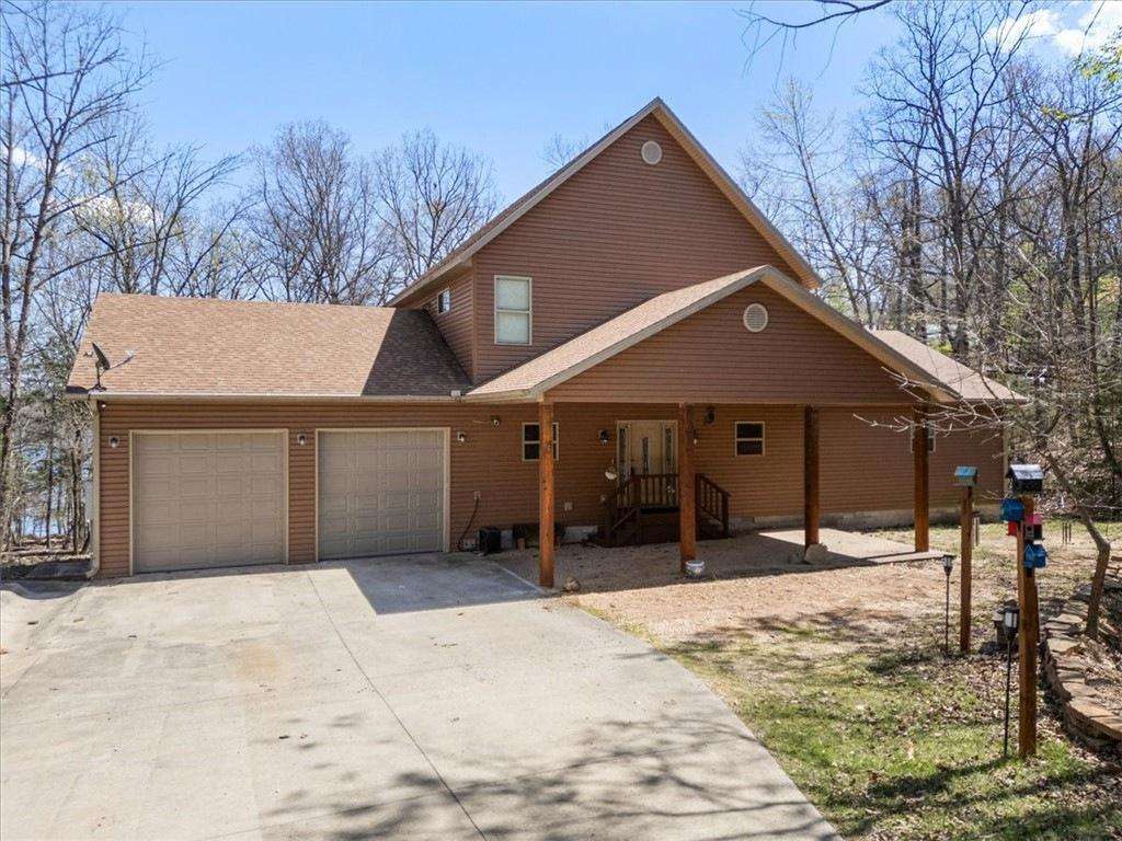 Spacious cabin retreat with covered porch and wooded privacy - property