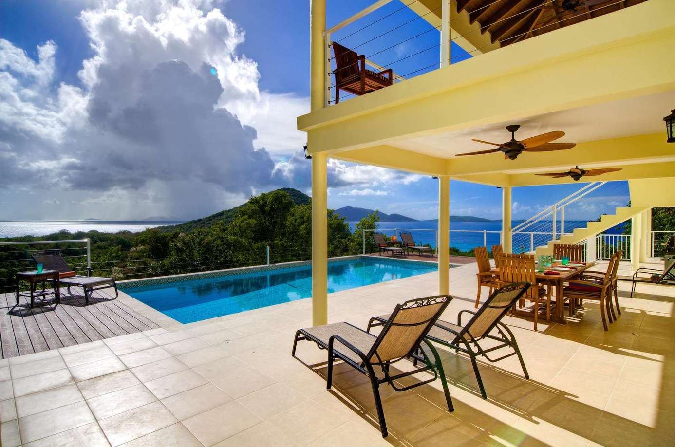 Sunlit patio with pool and panoramic mountain views