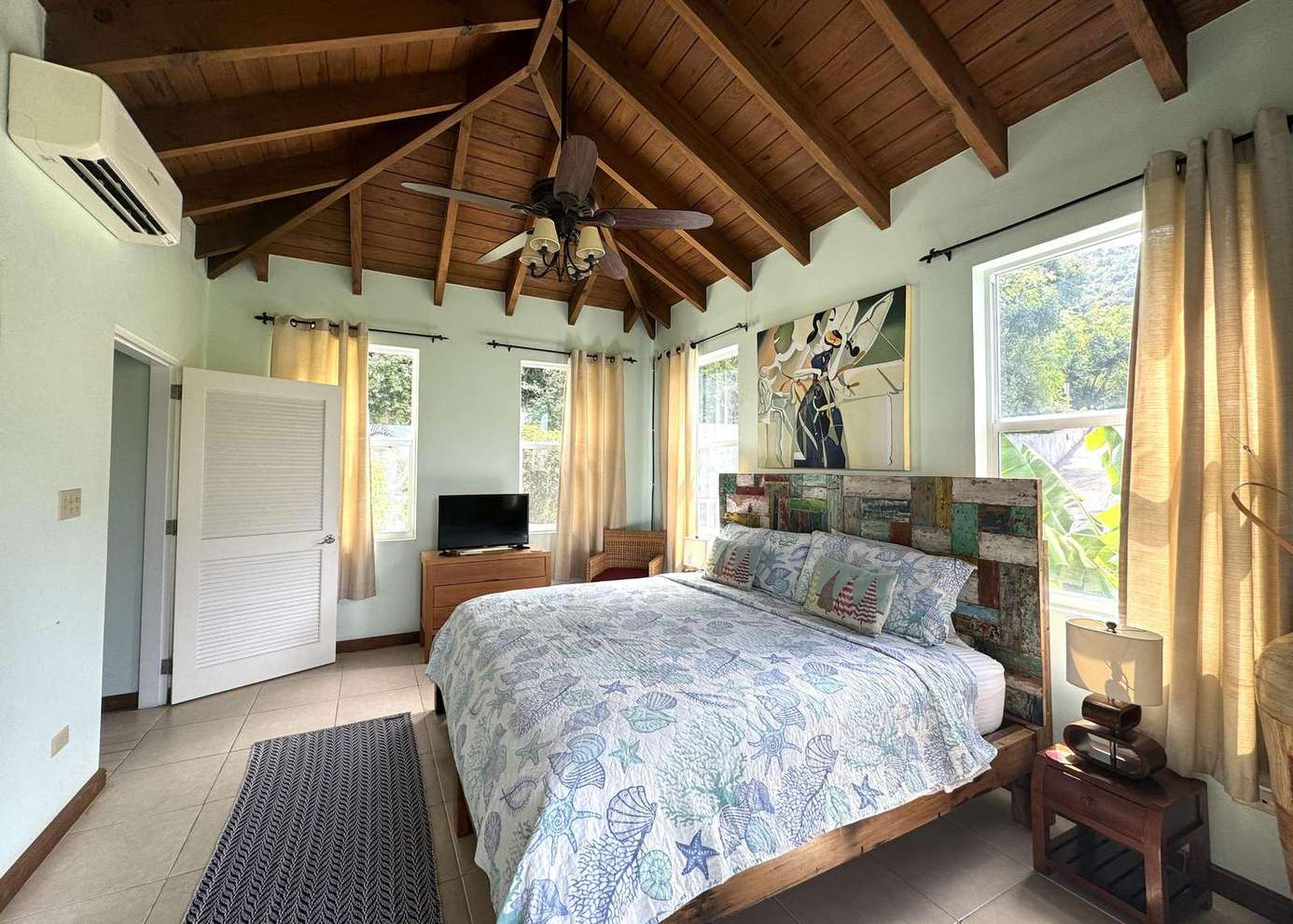 Cozy bedroom retreat with vaulted ceilings and natural light