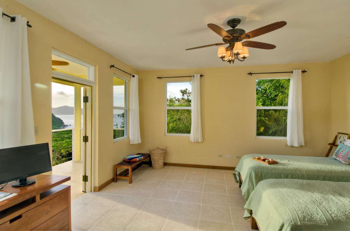 Bright and airy bedroom with scenic window views and cozy twin beds