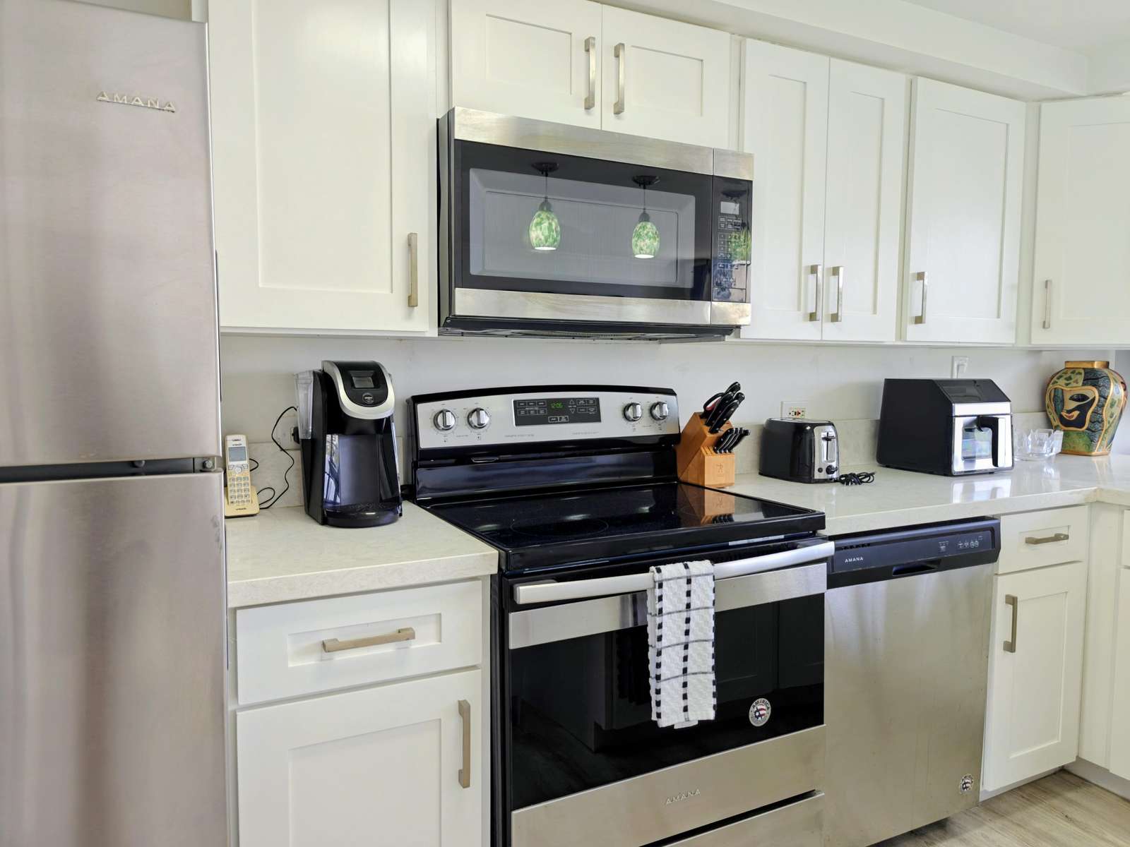 Modern kitchen with stainless steel appliances and bright cabinetry