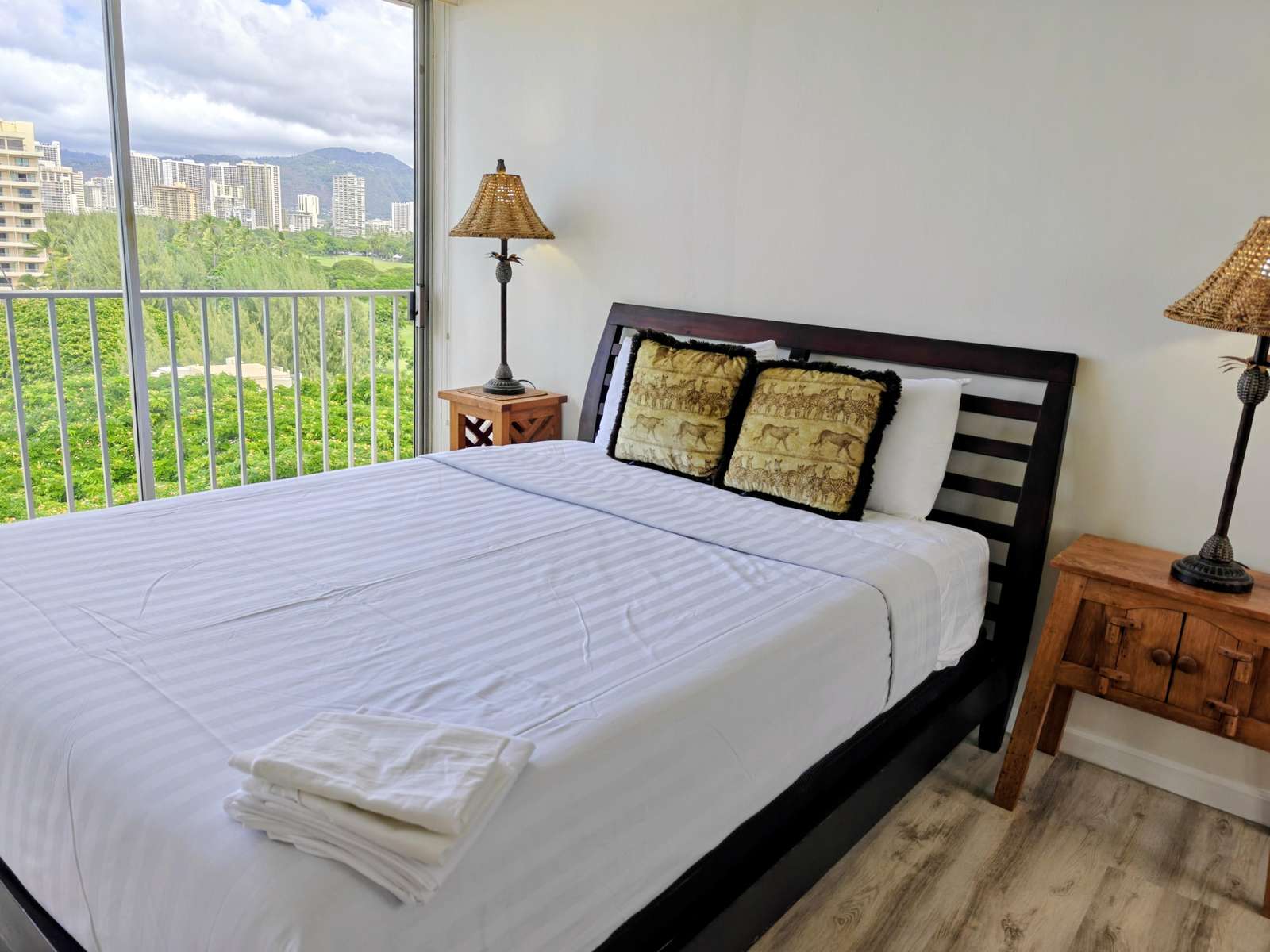 Bright bedroom with city views and cozy wooden accents