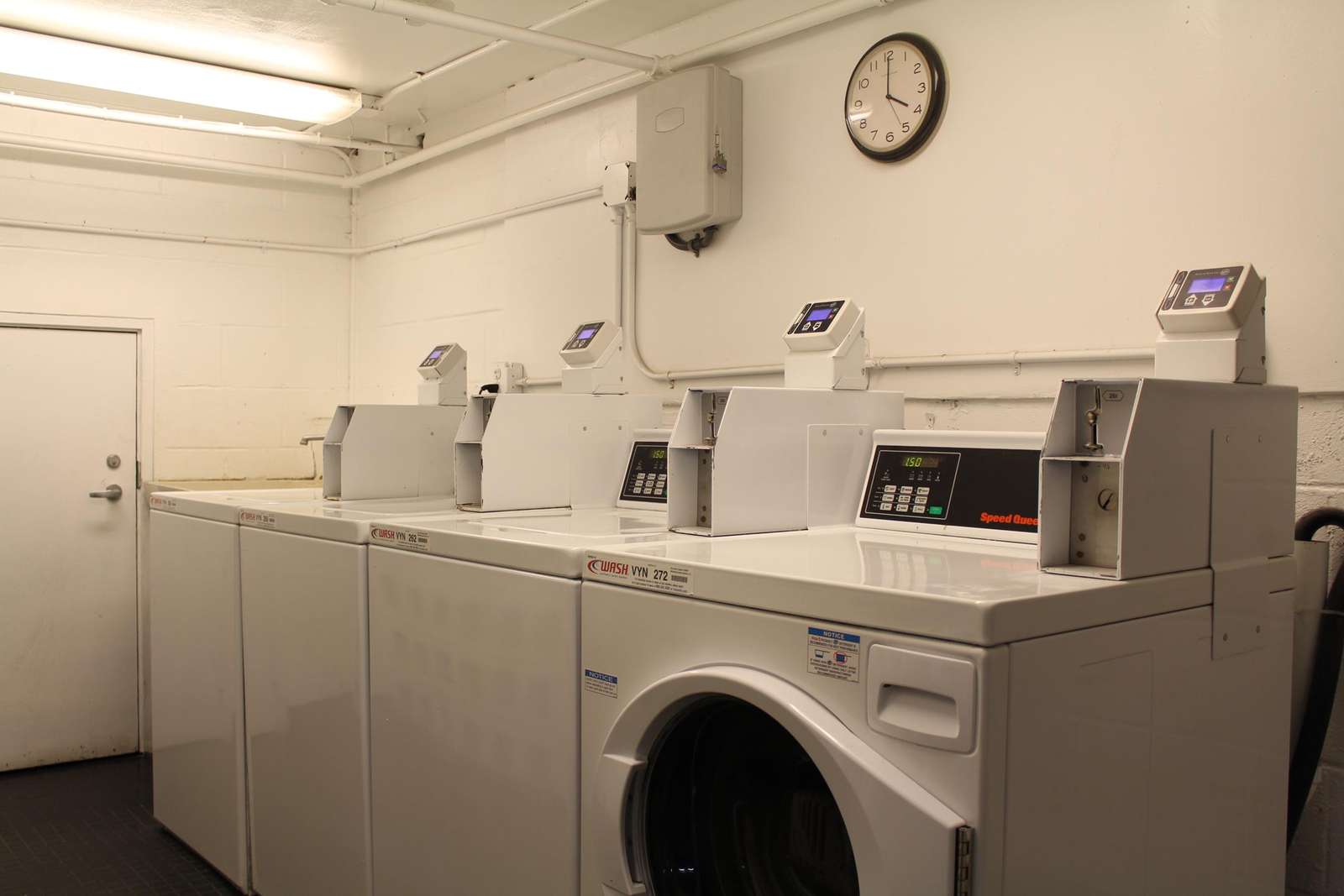 Bright, efficient laundry room with multiple washers and dryers