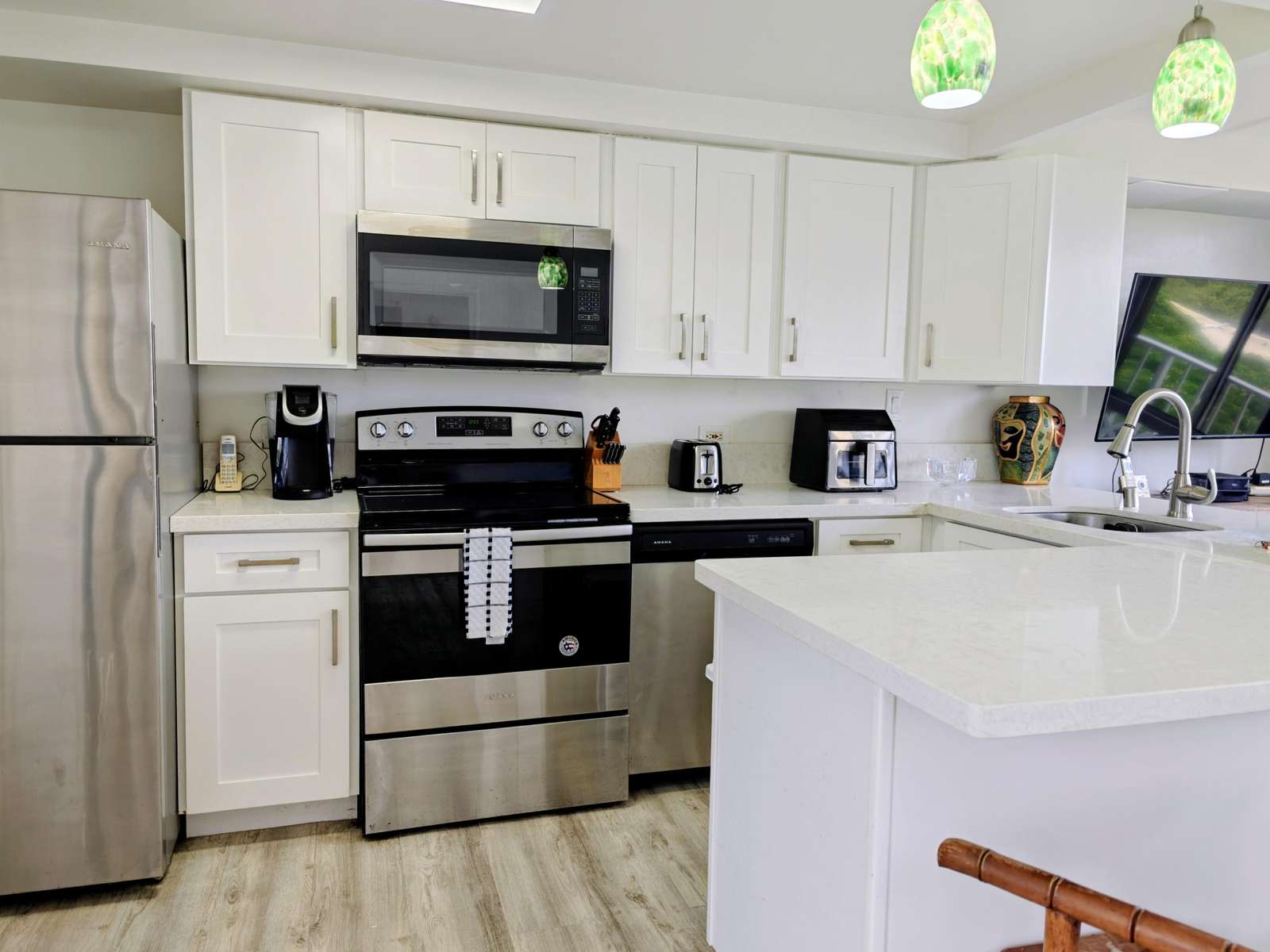 Modern kitchen with sleek stainless steel appliances and bright countertops
