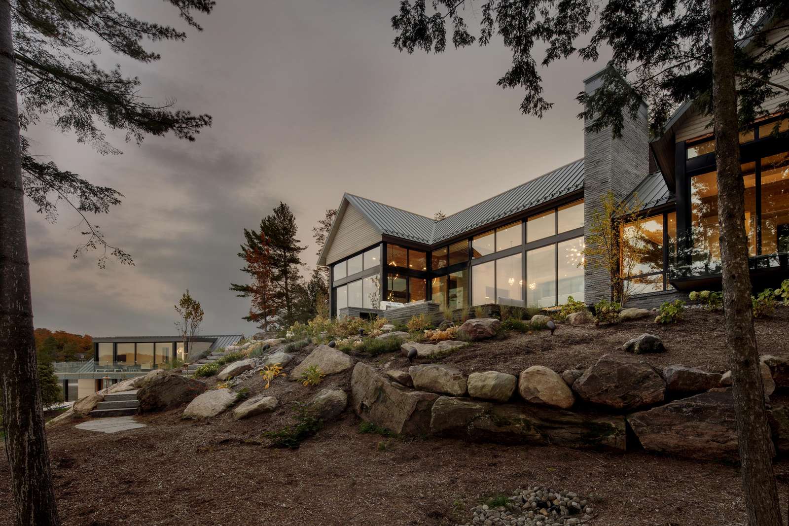 Modern lakeside retreat with expansive glass walls and serene views
