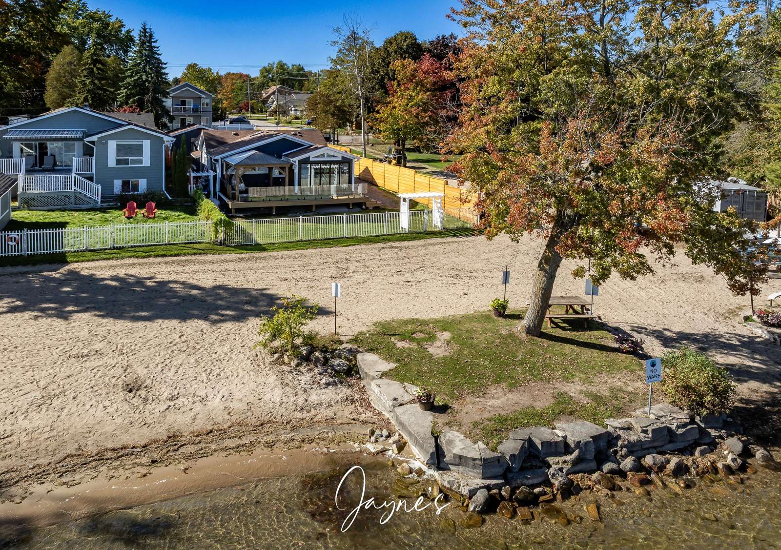 Charming lakeside yard with private beach access and cozy seating