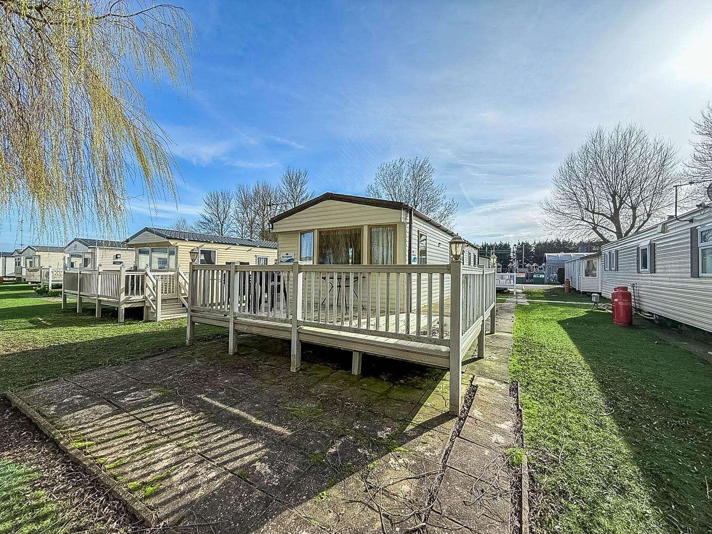 Enjoy sunny mornings on the decking with your morning coffee watching the world go by. - property