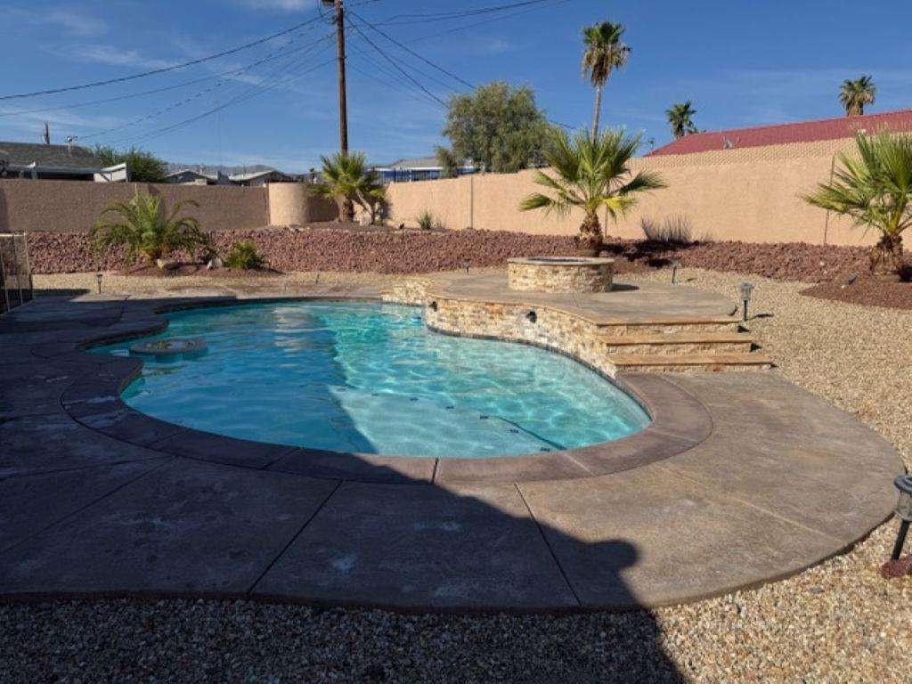Private backyard oasis with sparkling pool and desert landscaping - property