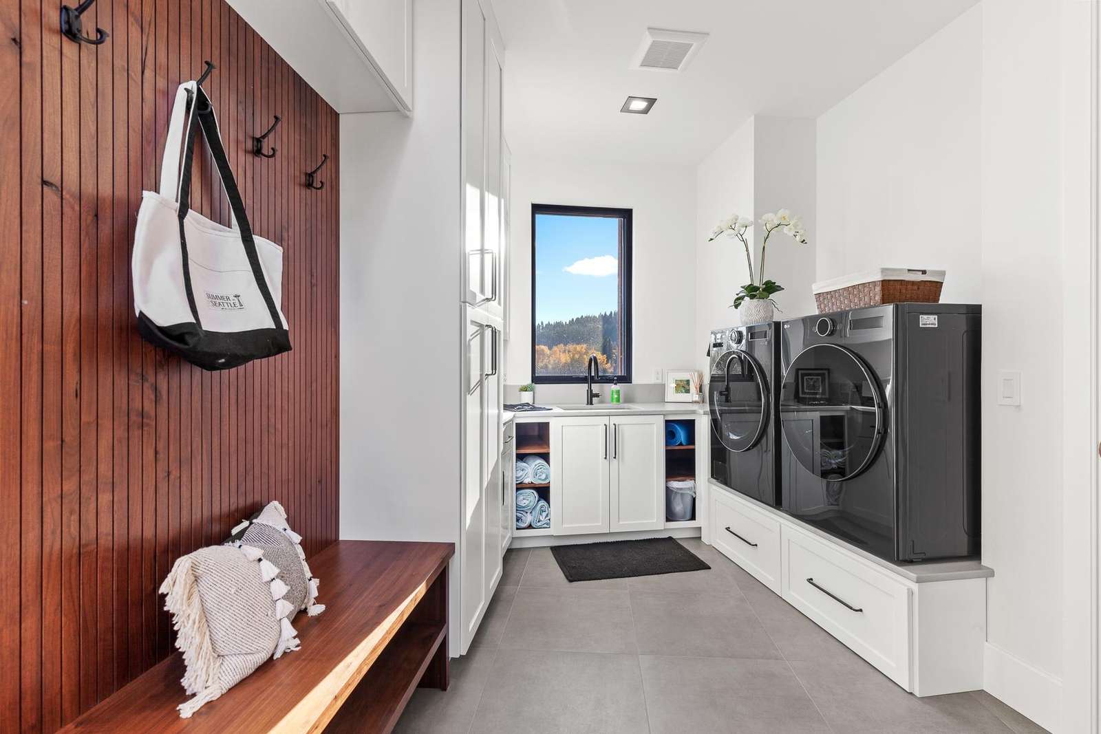 Bright, organized laundry room with built-in storage and seating