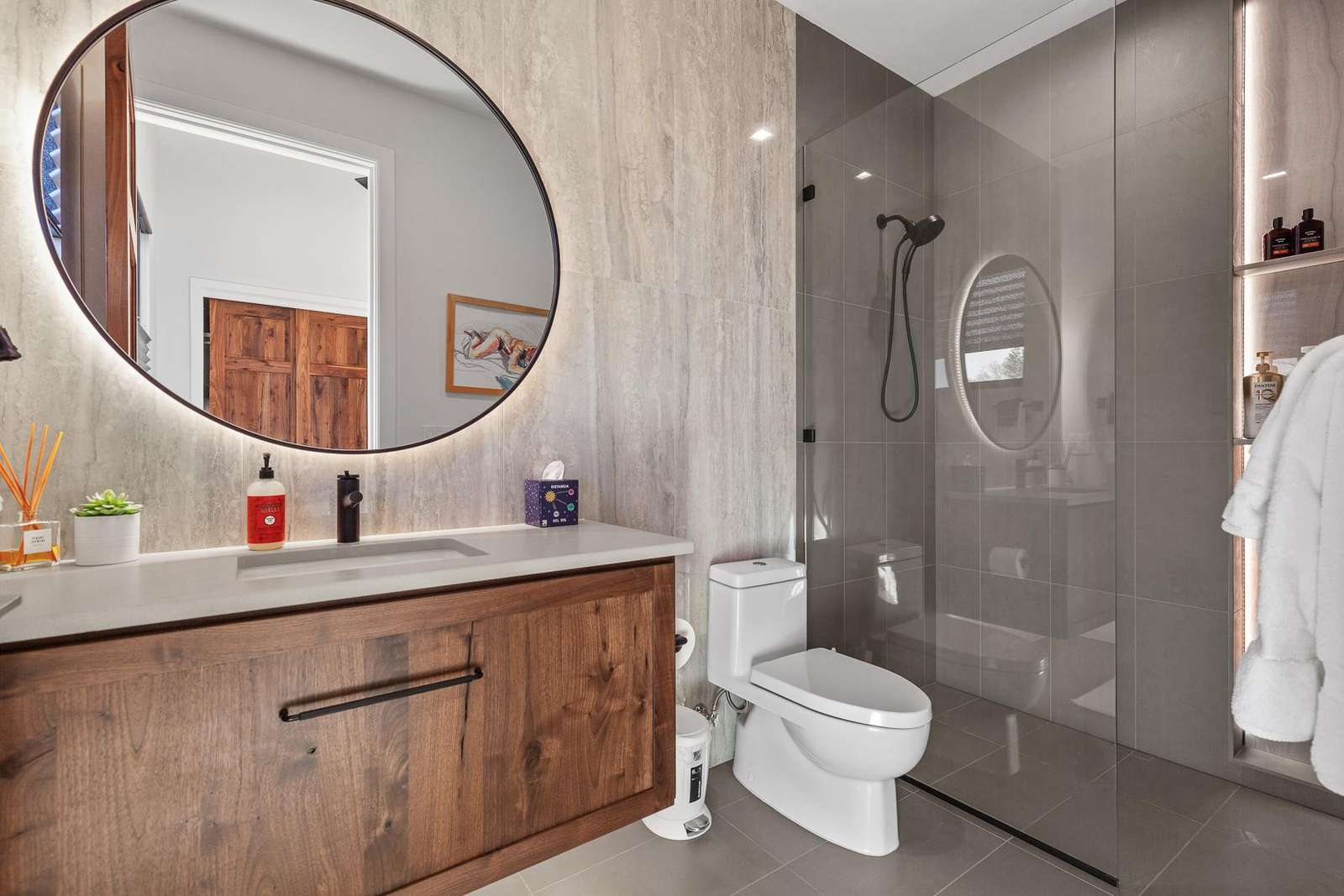 Modern bathroom retreat with sleek glass shower and warm wood accents