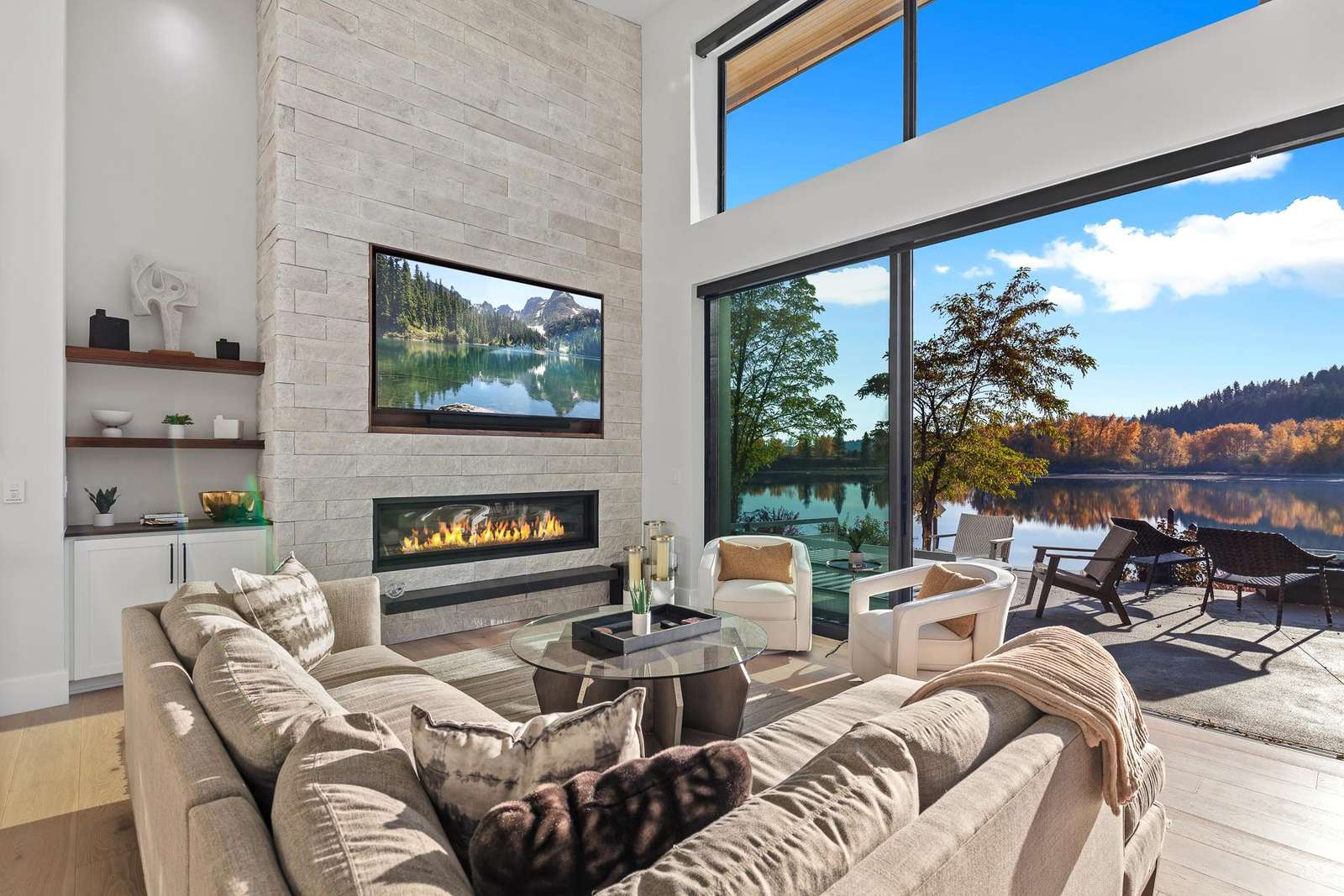 Sunlit living room with panoramic views and cozy fireplace