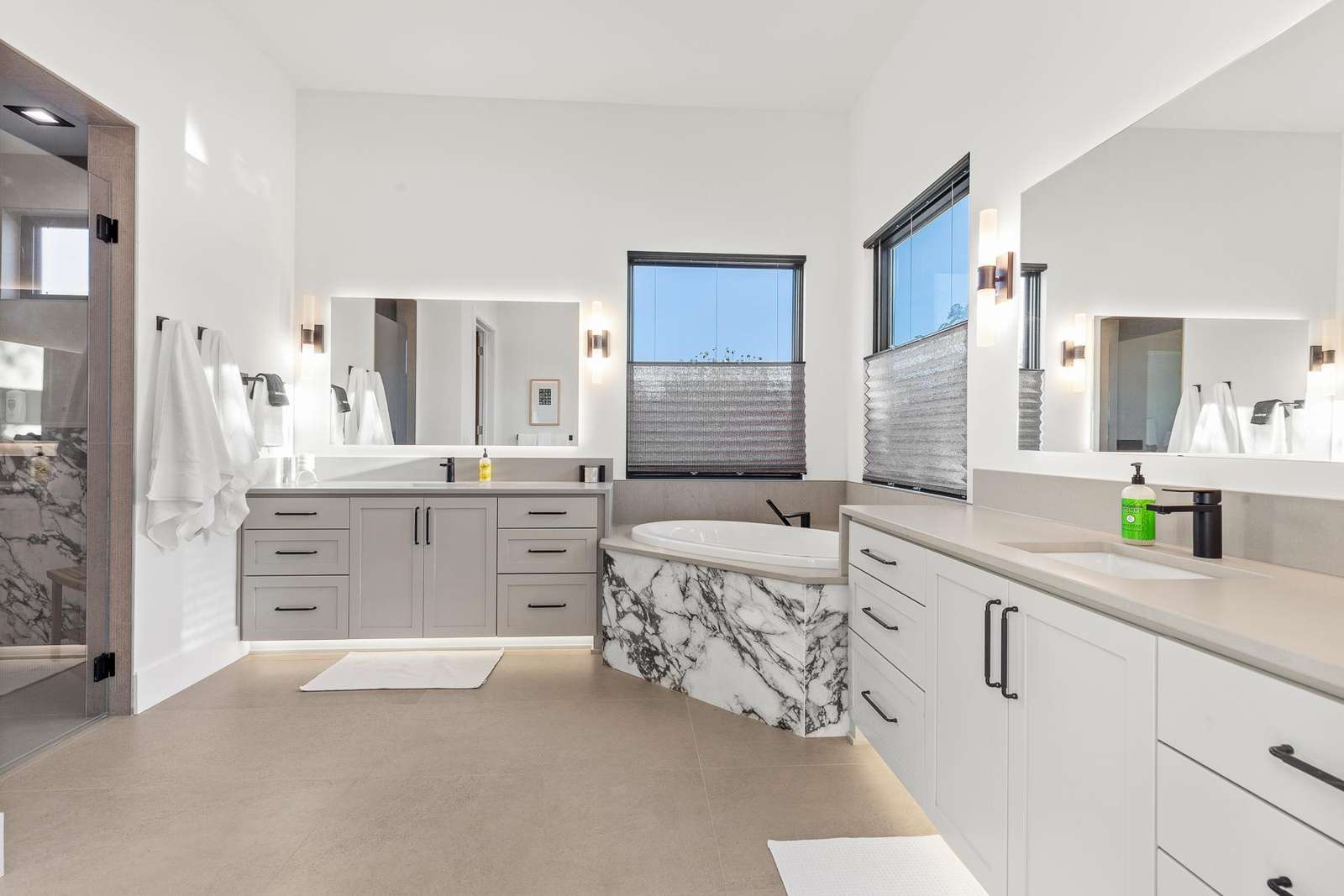 Spacious bathroom retreat with marble accents and natural light